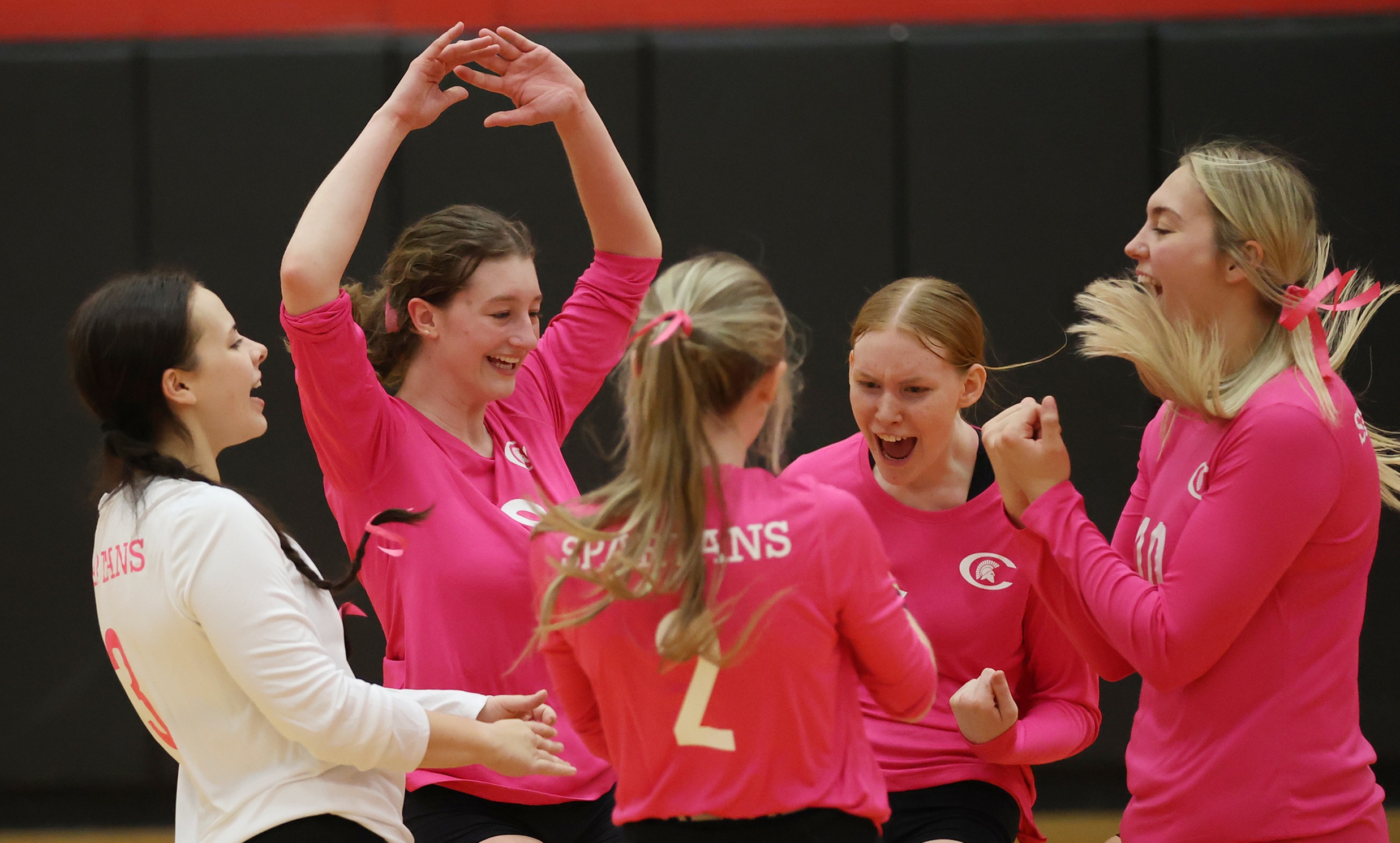 The Spartans celebrate an ace during their 3-0 win over Tompkins Cortland CC to close the 2022 season.